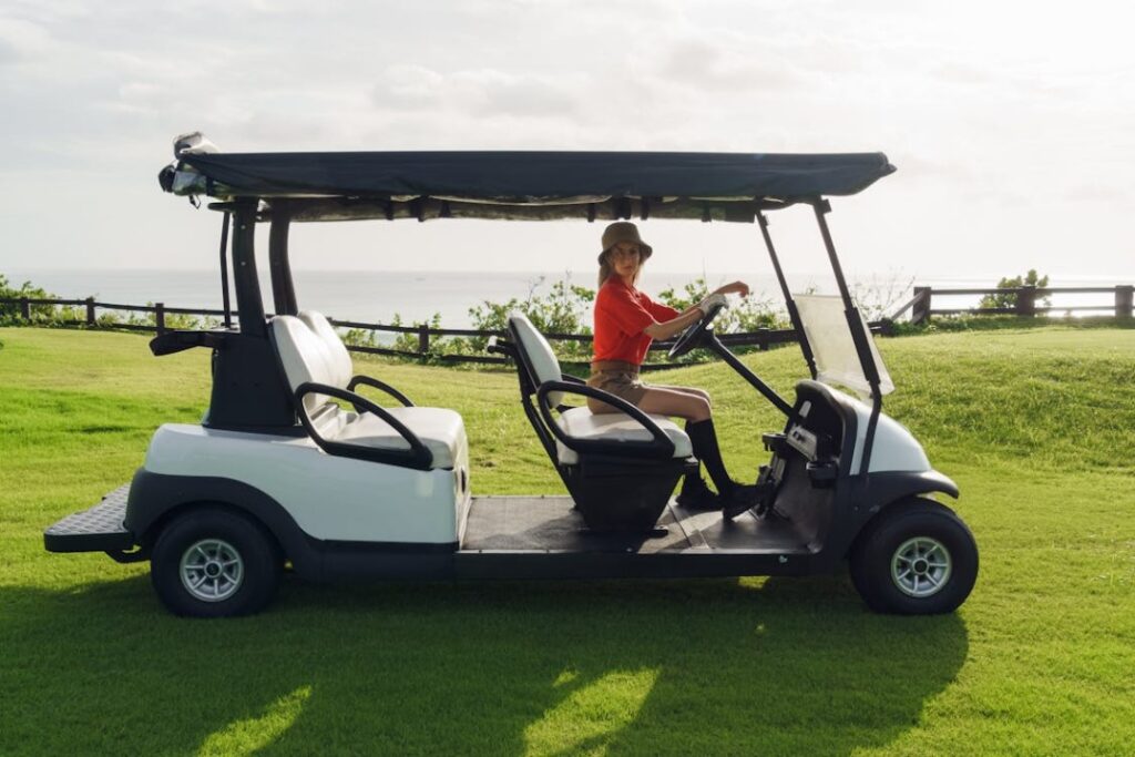 A golfer riding a Yamaha golf cart